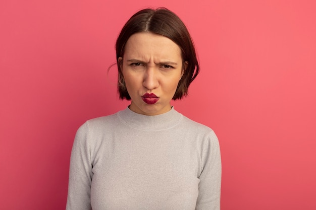 Free Photo | Unpleased pretty caucasian woman looks at camera on pink