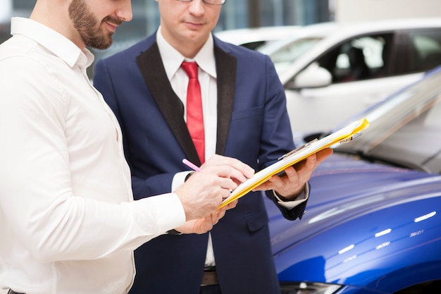 Premium Photo Unrecognizable Man Buying New Car At Dealership