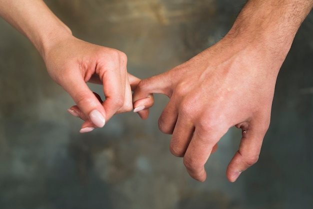 Unrecognizable Young Lovers Holding Little Fingers Free Photo