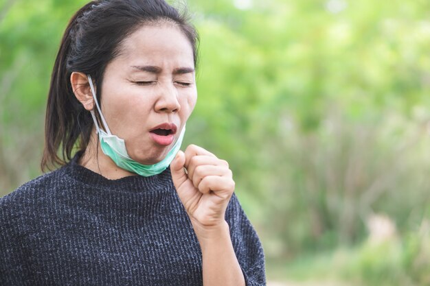 Premium Photo | Unwell asian woman coughing outdoors