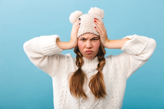 Premium Photo | Upset girl wearing sweater standing isolated