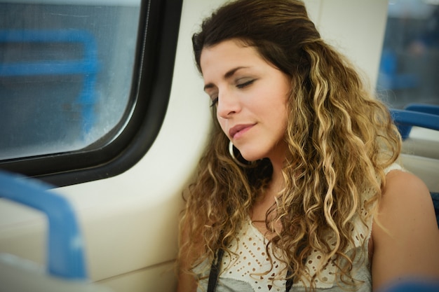 Premium Photo | Urban woman sleeping in a train travel beside the window.