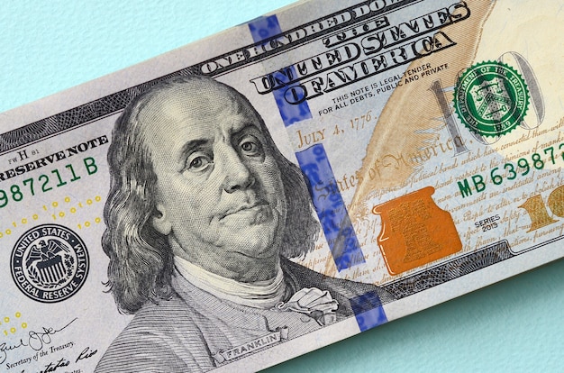 Premium Photo | Us dollar bills of a new design with a blue stripe in ...