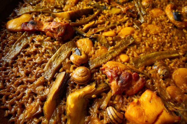 Premium Photo | Valencian paella with chicken and rabbit