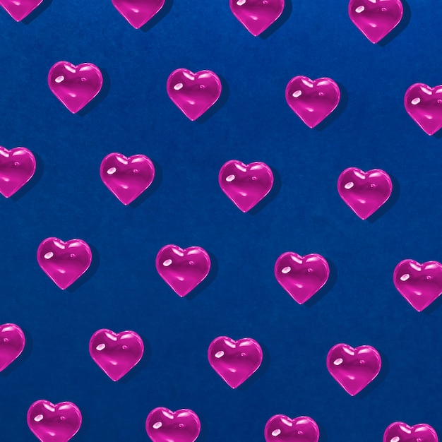 バレンタインデーの背景 青にピンクのガラスのハートのパターン プレミアム写真