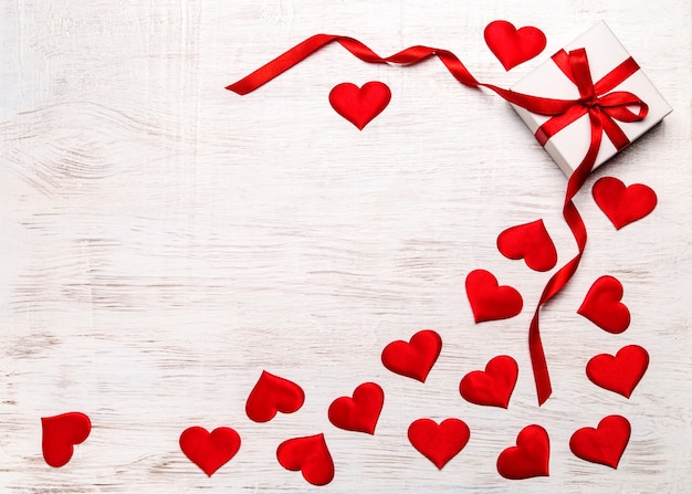 Premium Photo | Valentine's day background. . with gift and red hearts ...