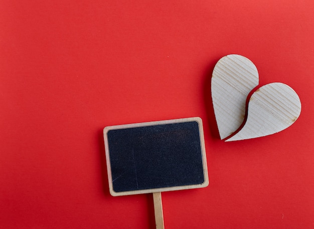 Premium Photo | Valentines day wooden heart on red background