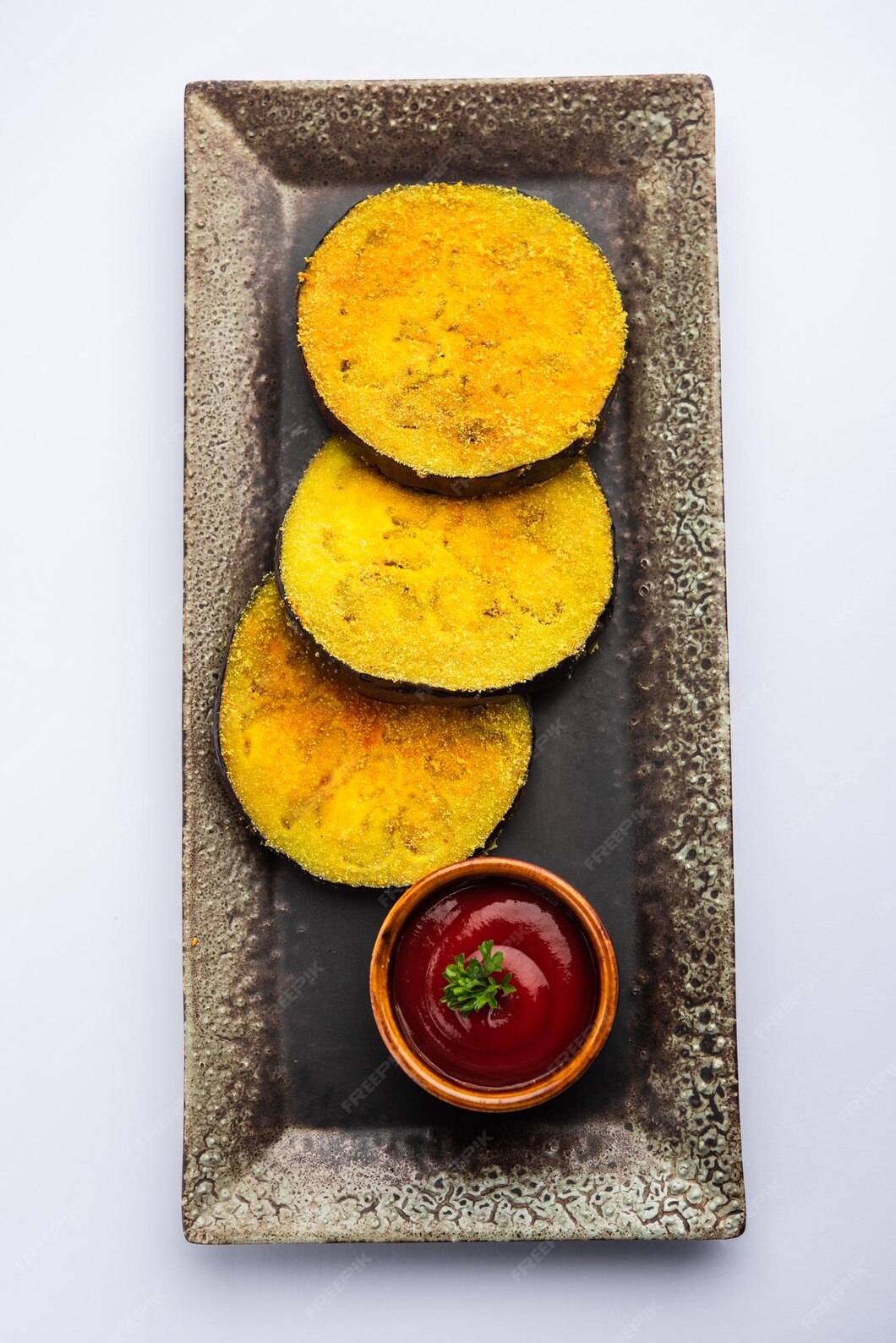 Premium Photo | Vangyache kaap or pan fried crispy eggplant, indian ...