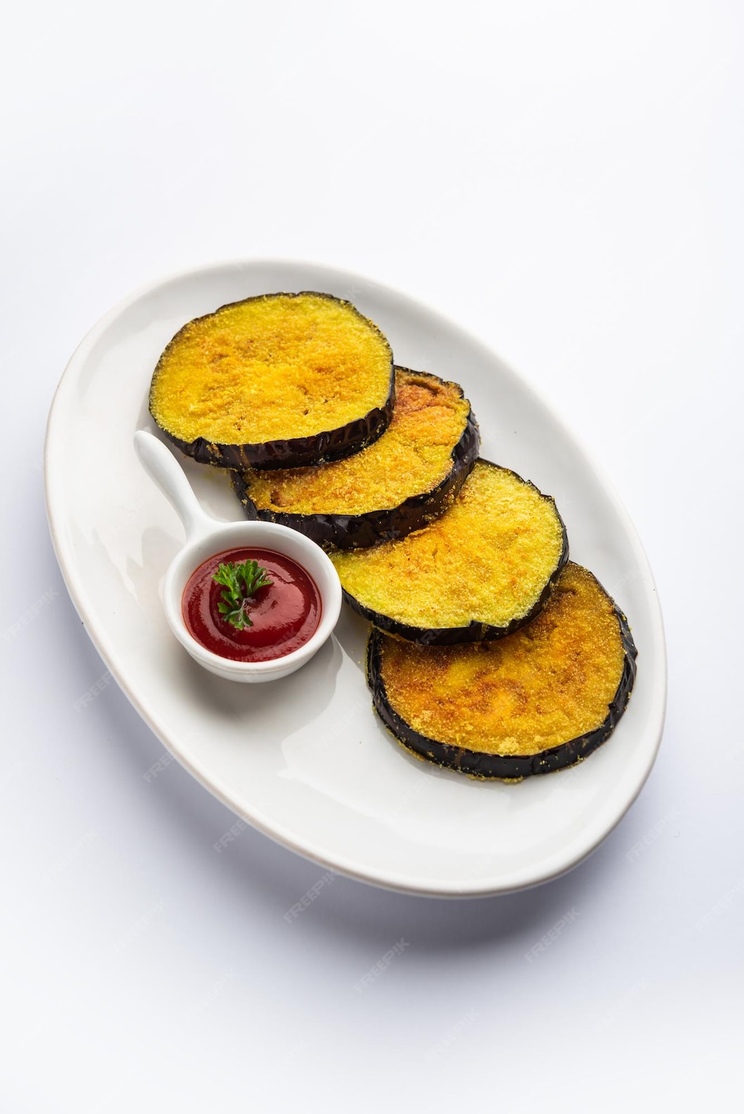 Premium Photo | Vangyache kaap or pan fried crispy eggplant, indian ...