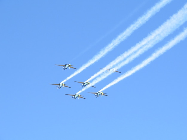 Premium Photo | Various acrobatic planes giving off smoke