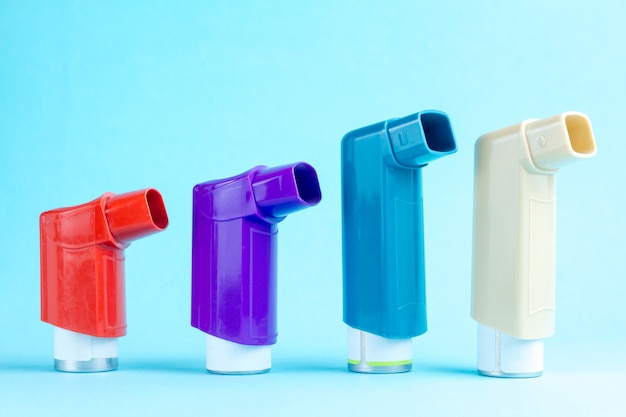 Premium Photo | Various asthma inhalers on blue