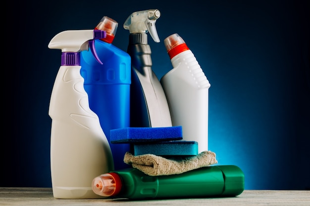 Premium Photo | Various bottles of cleaning products on a blue background.