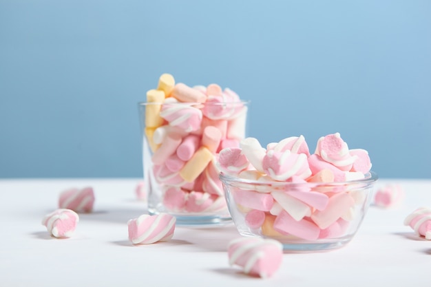 色付きの背景のテーブルにさまざまなお菓子やお菓子 プレミアム写真