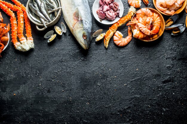 Premium Photo | Various dietary seafood. on black rustic background