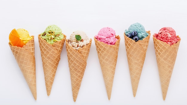 Premium Photo | Various of ice cream flavor in cones setup on white ...