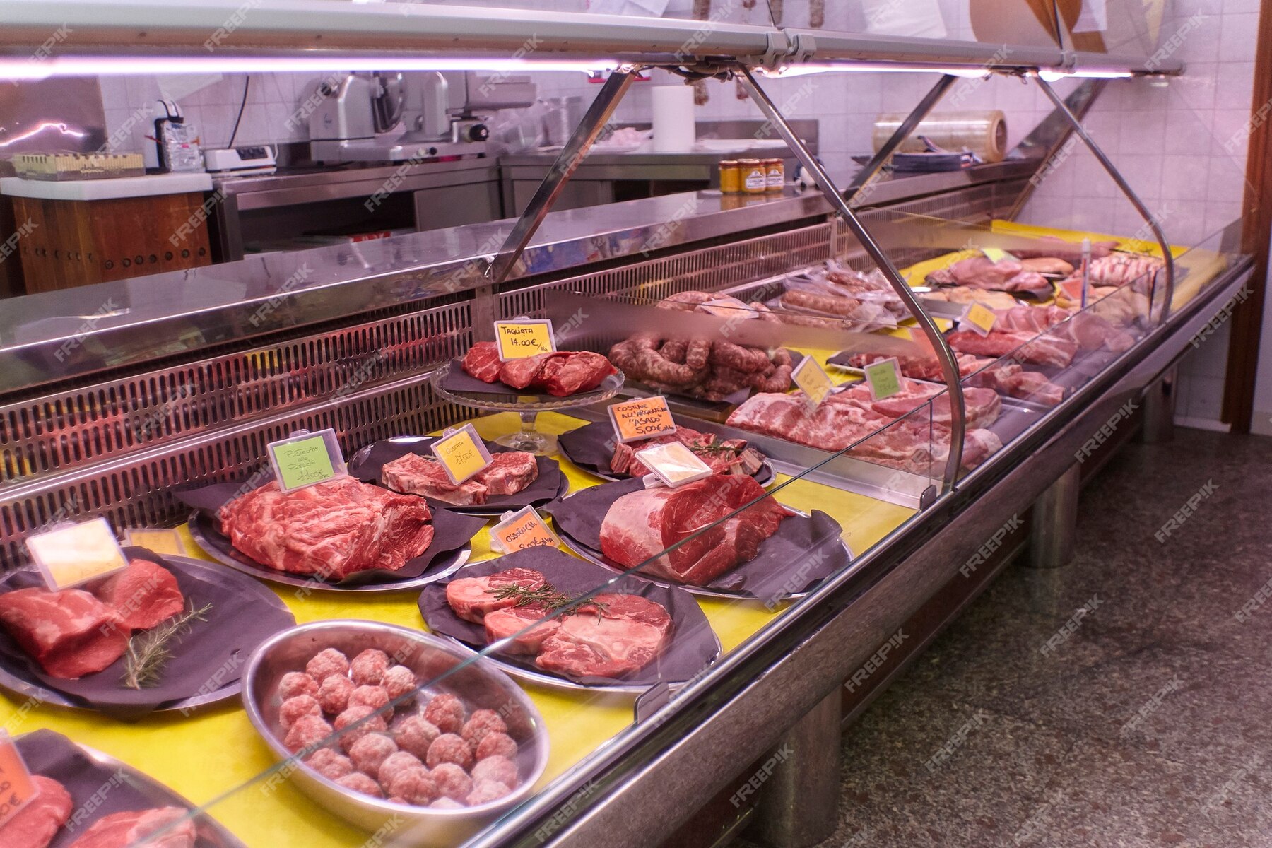 Premium Photo | Various meat cuts exposed in the butchery fridge counter