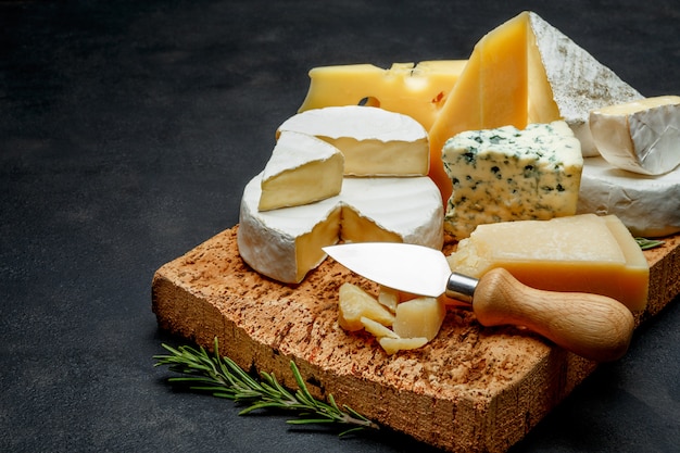 Premium Photo | Various types of cheese - parmesan, brie, roquefort ...