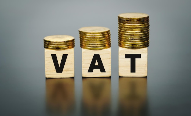 Premium Photo | Vat concept with stacked gold coins on wooden blocks