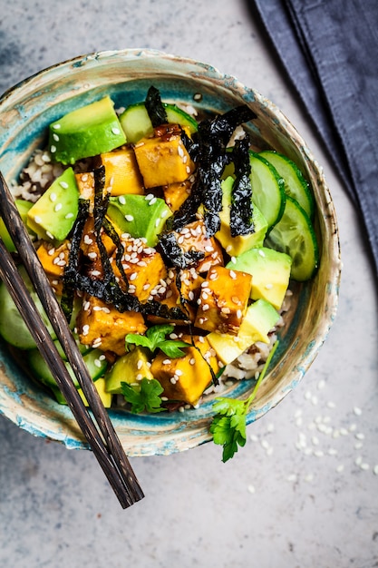 Premium Photo | Vegan tofu poke bowl with rice, cucumber, avocado and ...