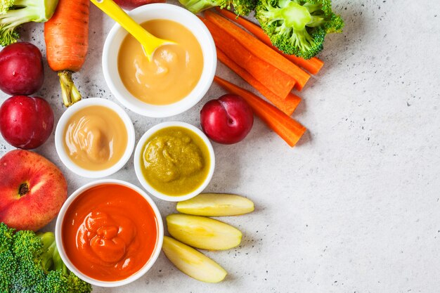 Premium Photo | Vegetable and fruit baby puree in white bowls with ...