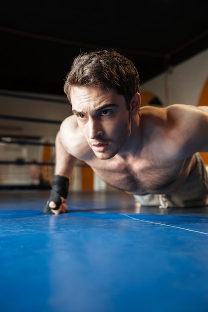 Premium Photo | Vertical image of boxer doing push ups