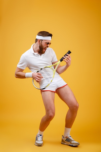 Free Photo | Vertical image of funny sportsman playing on tennis racquet