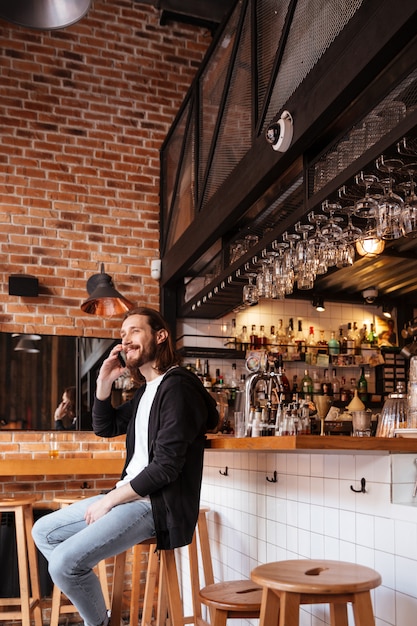 Free Photo | Vertical image of man sitting on bar