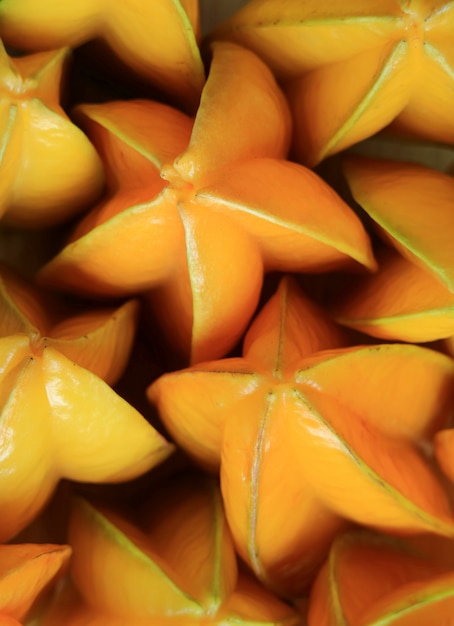 Premium Photo | Vertical photo of many vibrant color ripe star fruits