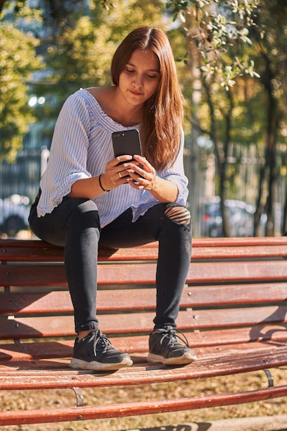 Beautiful Young Woman Typing On Smartphone Outside Stock 