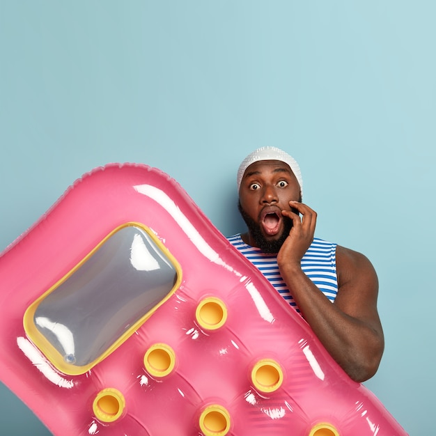 Free Photo | Vertical shot of puzzled horrified black man has widely ...