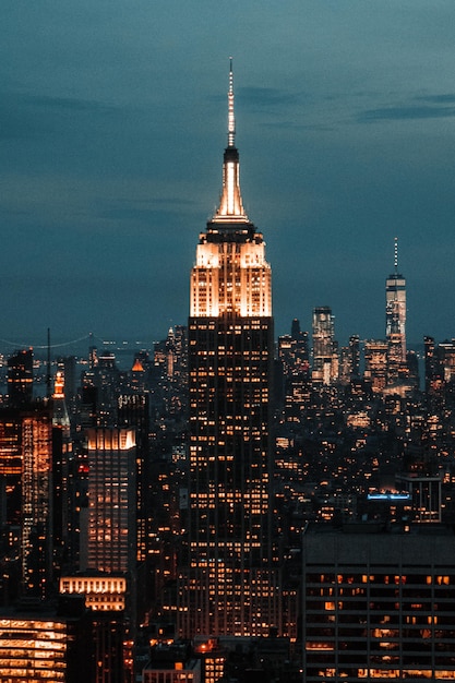 Free Photo | Vertical shot of a skyscraper surrounded by city buildings ...