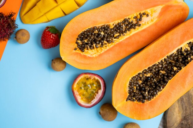 Premium Photo | Vertical shot of tropical fruits on orange blue ...