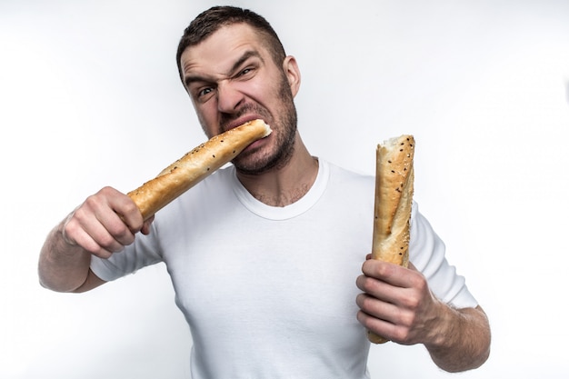 Premium Photo | Very hungry man with baguette