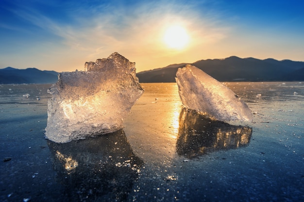 Very large and beautiful chunk of ice at sunrise in winter Free Photo