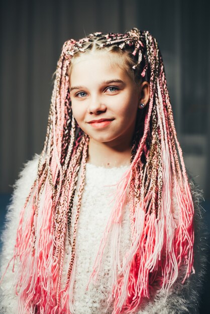 Premium Photo | A very sweet girl with braided pigtails with a thread ...