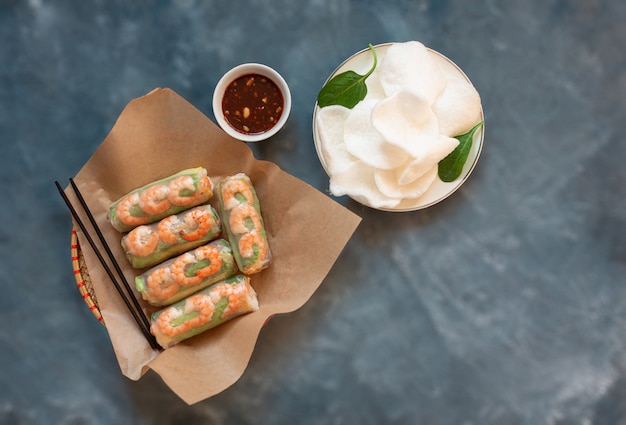 Premium Photo Vietnamese Spring Rolls And Rice Chips On A Gray