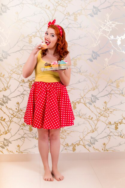 Premium Photo | View of a beautiful pinup redhead girl holding a tray ...