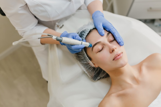 Free Photo | View from above rejuvenation of beautiful woman enjoying  cosmetology procedures in beauty salon. dermatology, hands in blue glows,  healthcare, therapy, botox