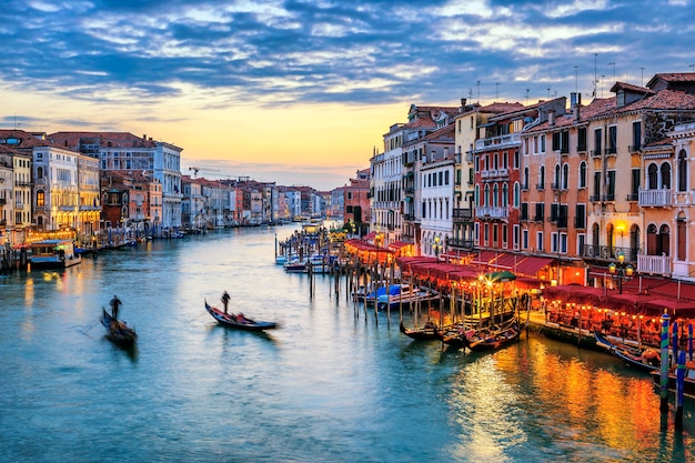 Premium Photo | View of grand canal with gondolas at sunset in venice