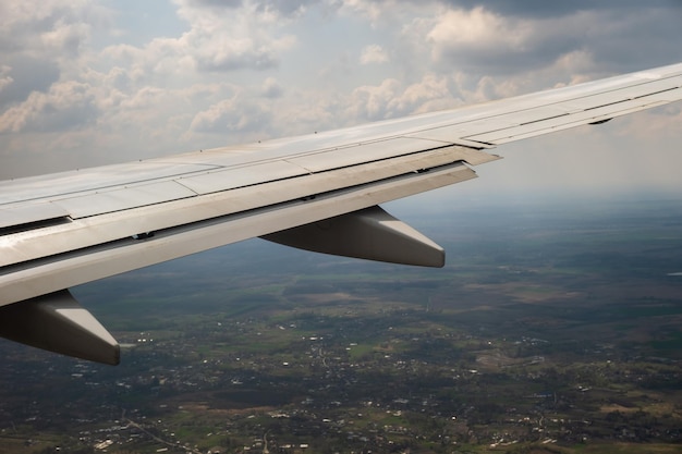 Premium Photo | View of jet airplane wing landing at airport in bad ...