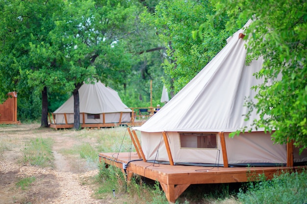 Premium Photo | View of modern camping tents in the glamping area ...