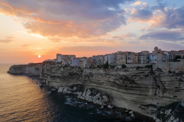 Free Photo | Village on a cliff over the ocean at sunset