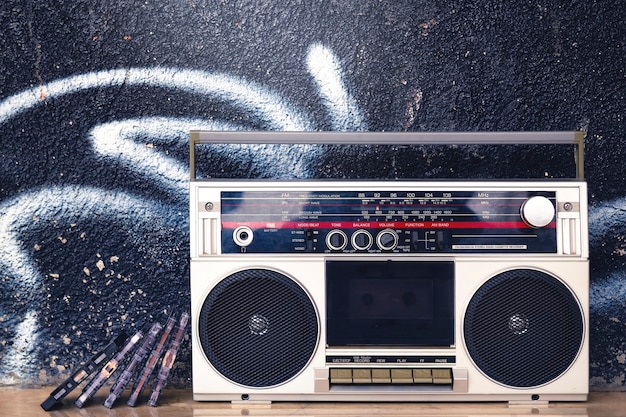 Premium Photo Vintage Boombox With Cassettes On The Floor On A Graffiti