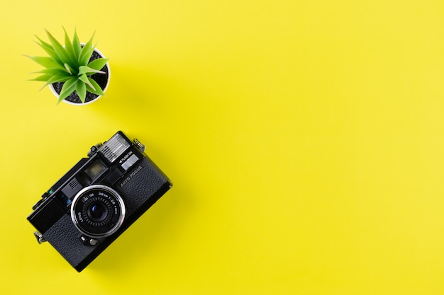 Premium Photo | Vintage camera on yellow background with copy space ...