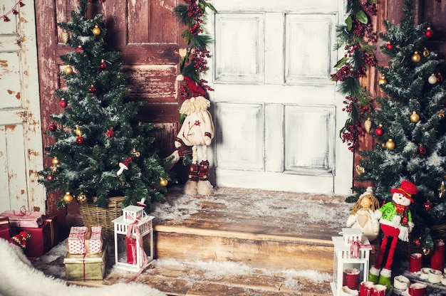 Premium Photo | Vintage christmas decoration of front door with gifts ...