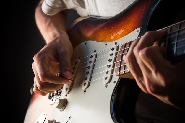 Premium Photo Vintage Electric Guitar Closeup Male Hands Playing With A Pick