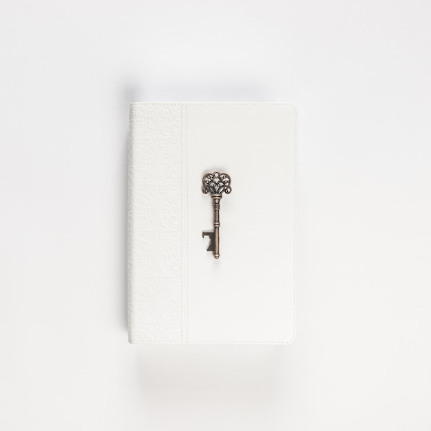 Vintage key on white book on white Free Photo