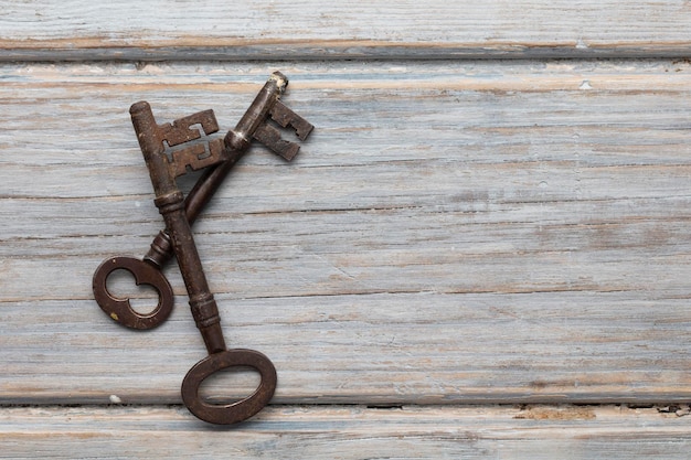 Premium Photo | Vintage old fashioned keys on a rustic wooden