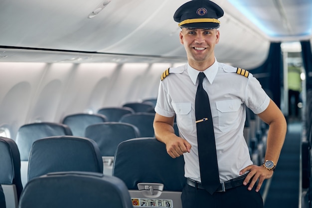 Premium Photo | Waist up portrait of main pilot wearing uniform and cap ...