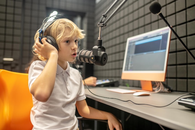 Premium Photo | Waist-up portrait of a serious concentrated young boy ...